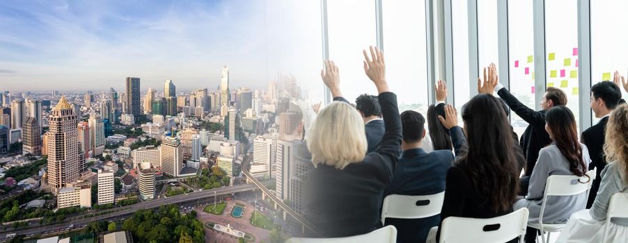 Group of business people meeting in a seminar conference widen view . Audience listening to instructor in employee education training session . Office worker community summit forum with speaker .