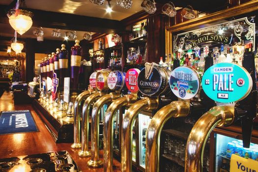 Oxford, UK - 02 March 2020: Rows of draught beer in a typical British pub