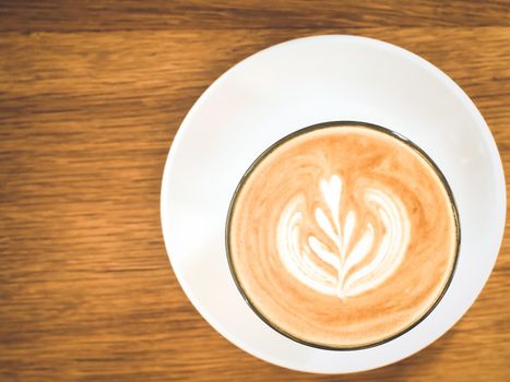 hot milk coffee on white glass plate wooden table background brown tone lifestyle concept idea