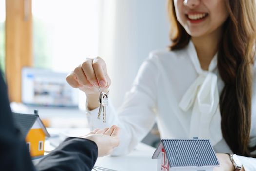Guarantee, mortgage, agreement, contract, sign, real estate agent delivers the keys to the customer after signing important contract documents.