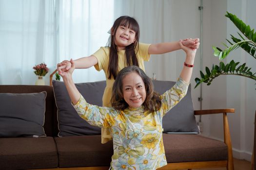 Asian portrait, grandma and granddaughter doing leisure activities and hugging to show their love and care for each other.