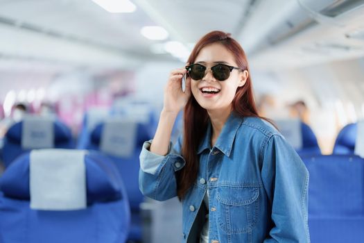 travel business Portrait of an Asian woman showing joy while waiting for a flight.