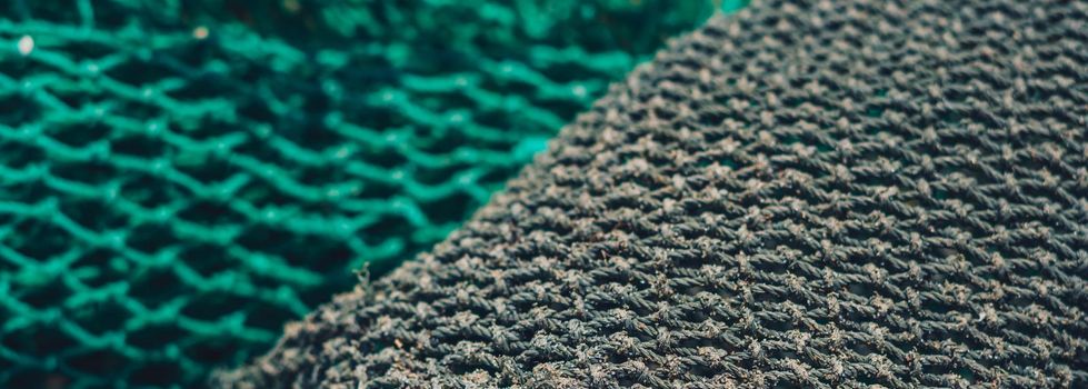 BANNER abstract close-up macro real photo beautiful wallpaper. Fisherman rope net texture fiber surface pattern. Sea blue green light colour. Futuristic subtle waving lines art modern Dark background