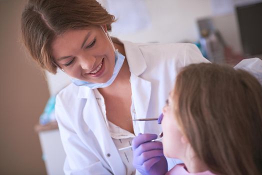 Cropped shot of a dentist examining a little girls teeth.