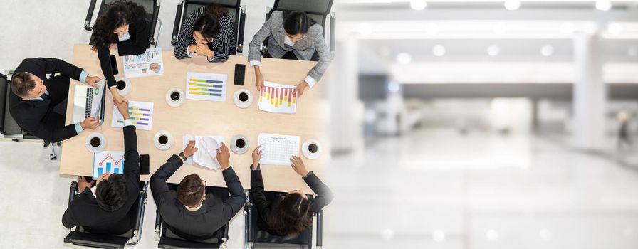 Business people group meeting shot from top view in office . Profession businesswomen, businessmen and office workers working in team conference with project planning document broaden view .