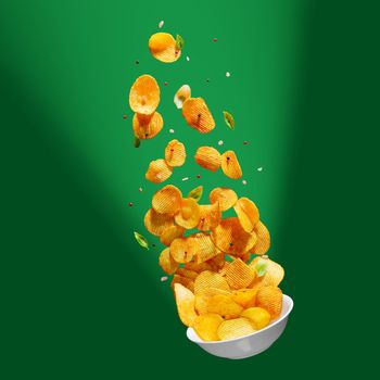 Tasty potato chips falling onto plate on colorfull background. Levitation flying potato chips with salt and peppers. Advertising concept.