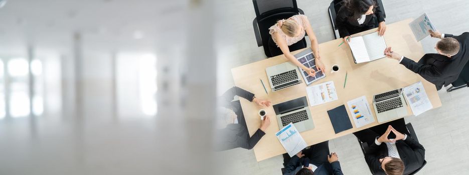 Business people group meeting shot from top widen view in office . Profession businesswomen, businessmen and office workers working in team conference with project planning document on meeting table .