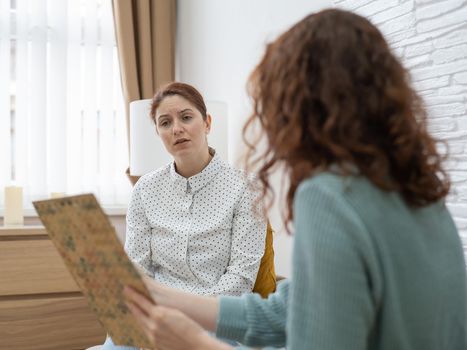 Worried caucasian woman at a session with a psychotherapist