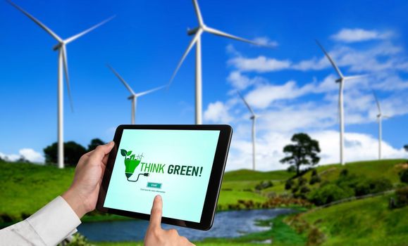 Green business transformation for environment saving and ESG business concept. Businessman using tablet to set corporate goal toward environmental friendly management and alternative clean energy use.