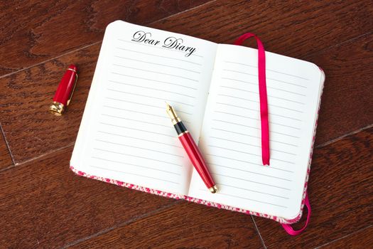 Blank entry of diary and fountain pen with "Dear Diary" written at the top of the page
