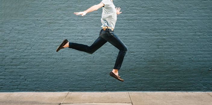 Man jumping against a wall