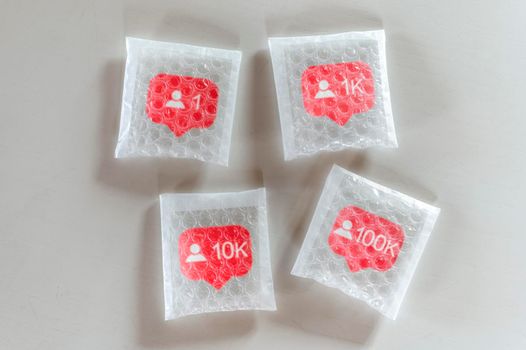 Packaging social symbols and icons with bubble wrap.