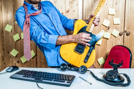 Man playing guitar in office