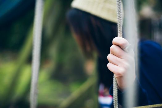 Lonely woman sitting on the swing