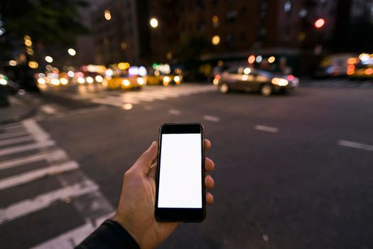 hand holding phone at night in the city