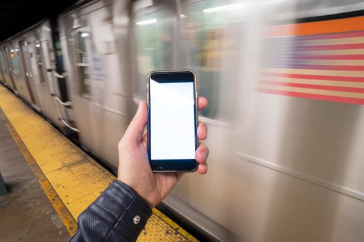 phone in hand in the subway