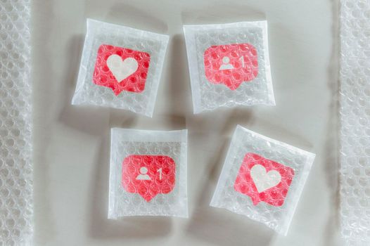 Packaging social symbols and icons with bubble wrap.