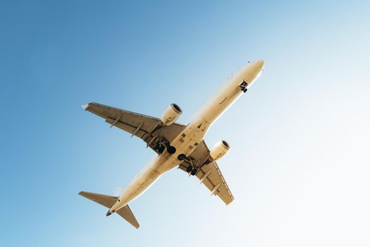 commercial plane flying seen from below, travel concept