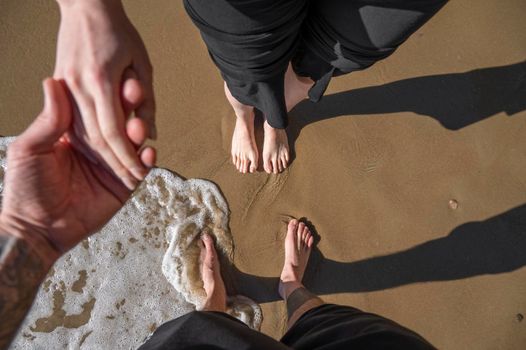 Couple together at beach hand in hand.