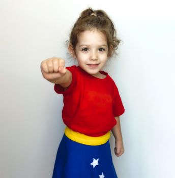 Portrait of a young cute girl posing as a super hero with Wonder Woman costume