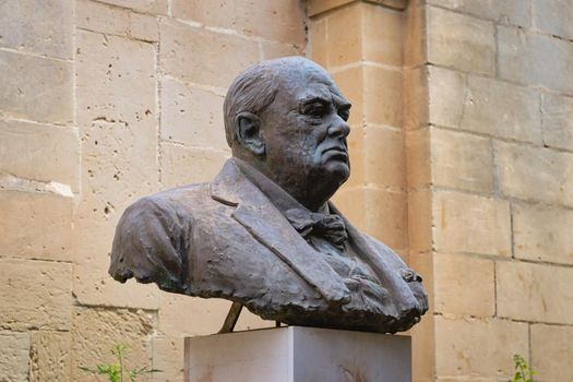 Metal bust of Winston Churchill set on a marble plinth