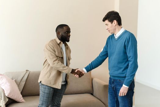 African american man shaking hands with psychologist after therapy session, thanks for help. Thanks for the work