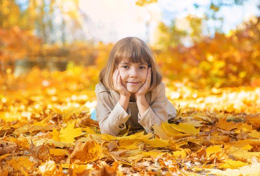 Children in the park with autumn leaves. Selective focus.