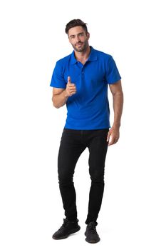 Successful young casual man showing thumbs up looking at camera. Full body length portrait isolated over white background.