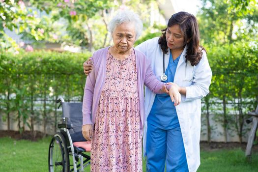 Doctor help and care Asian senior or elderly old lady woman patient sitting on wheelchair at nursing hospital ward, healthy strong medical concept