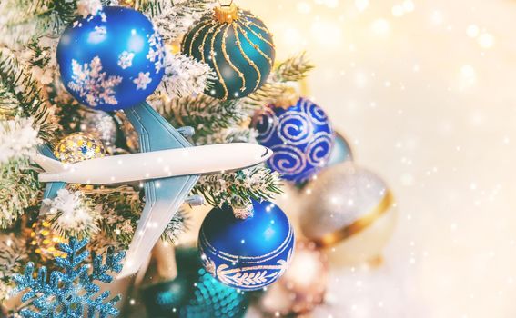 Beautiful christmas background with airplane. Travel concept for christmas and new year. Selective focus. Holiday.