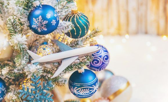 Beautiful christmas background with airplane. Travel concept for christmas and new year. Selective focus. Holiday.