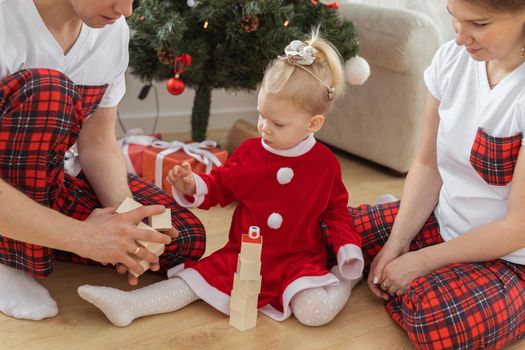 Toddler child with cochlear implant decorating christmas tree deafness and innovating medical technologies for hearing aid