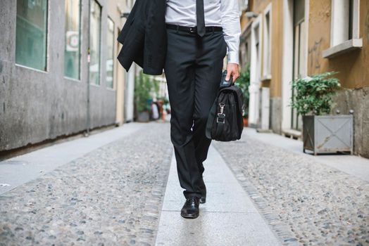 Elegant businessman walking in the city