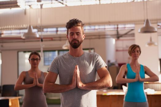 A group of people doing yoga together.