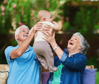 Cropped shot of a senior couple spending time with their grandson.