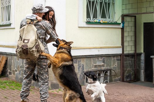 military father meeting with daughter and dogs.