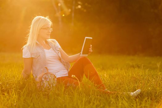 woman with tablet in the park.