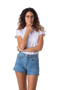 Beautiful pensive woman standing against a white background