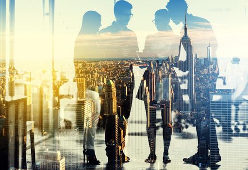 Multiple exposure shot of a group of businesspeople superimposed over a city background.