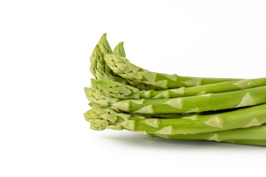 Fresh green asparagus on a white isolated background. Green asparagus isolate with shadow on white background