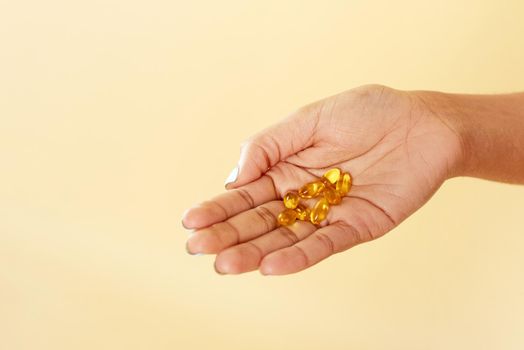 Black woman holding vitamin c pills. Smiling african lady using vitamins for healthy immunity or beauty. close hand.