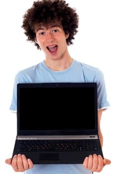 Male finds something funny online. Isolated on white.