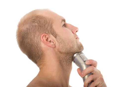 young man shaving his beard off with an electric razor isolated