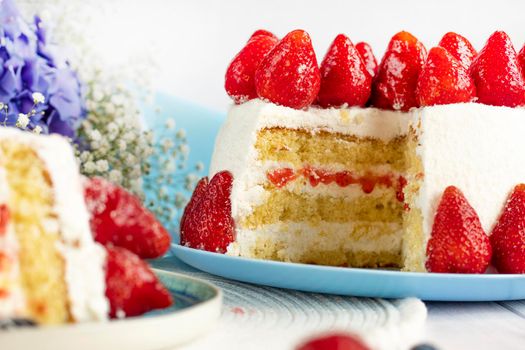 selective focus. festive berry cake. homemade strawberry cake cut. Strawberry pie decorated with fresh strawberries stands on a plate. Ice cream and strawberry cream. Cut off a piece.