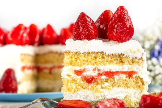 selective focus. festive berry cake. homemade strawberry cake cut. Strawberry pie decorated with fresh strawberries stands on a plate. Ice cream and strawberry cream. Cut off a piece.