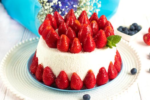 selective focus. Strawberry pie garnished with fresh strawberries. Homemade strawberries cake made from meringue cake and cream with strawberries. Decorated with icing and berries. birthday cake