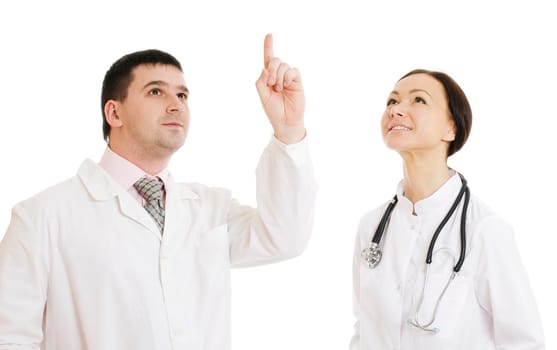 Two doctors male and female pointing finger upwards. Isolated on white.