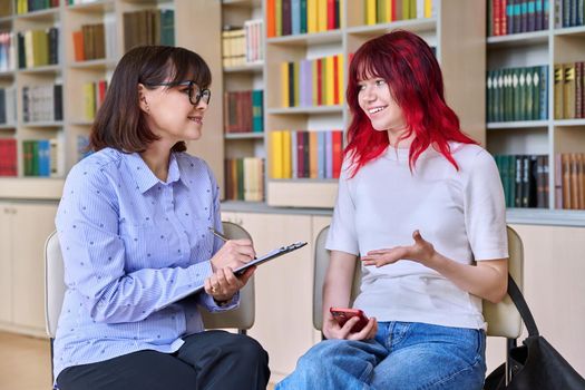 Psychologist, teacher, behavior, college counselor counseling teenage student in library, office. Psychological help, social work, mental health, adolescence, youth psychotherapy psychology concept