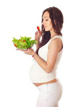 Pregnant woman eating chopped salad, isolated on white.