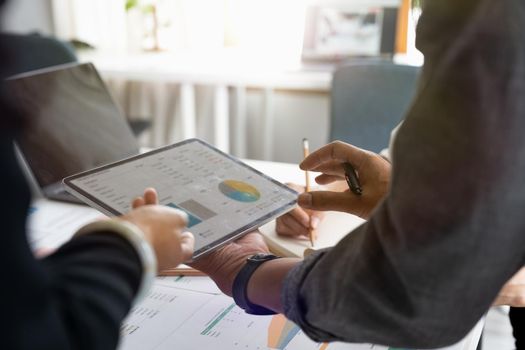 business partnership coworkers discussing a financial planning graph and company during a budget meeting in office room. business financial accounting concept